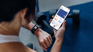 Woman using fitness tracker at the gym