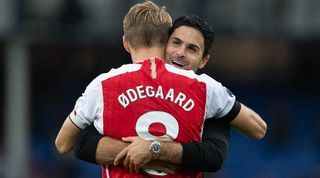 Arsenal manager Mikel Arteta embraces Martin Odegaard after a game against Everton in September 2023.