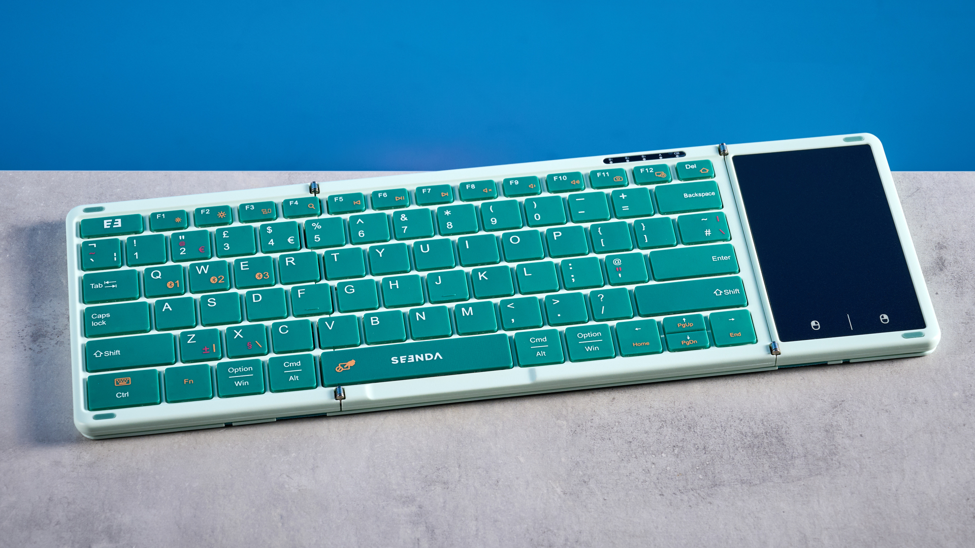 Seenda Foldable Bluetooth Keyboard with Touchpad pictured in front of a blue background.