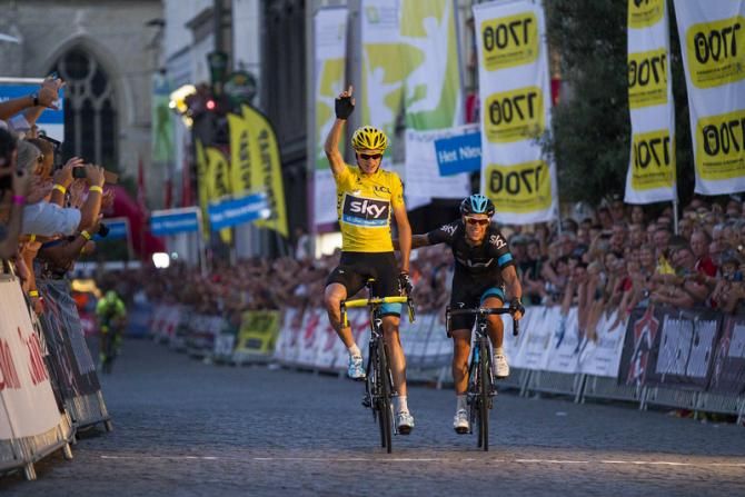 Chris Froome (Sky) salutes as he crosses the finish line alongside teammate Richie Porte