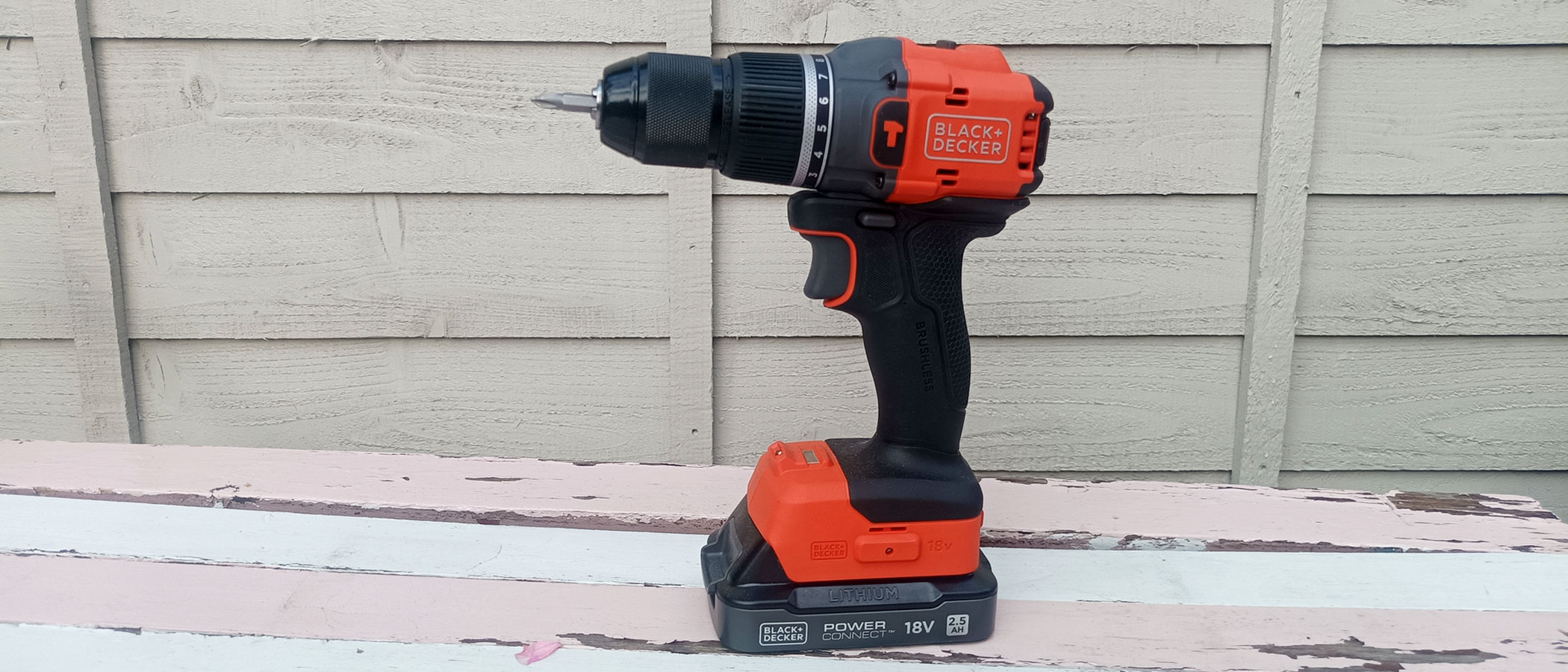 Black and orange Black &amp; Decker BLD783 Cordless Drill against wood background