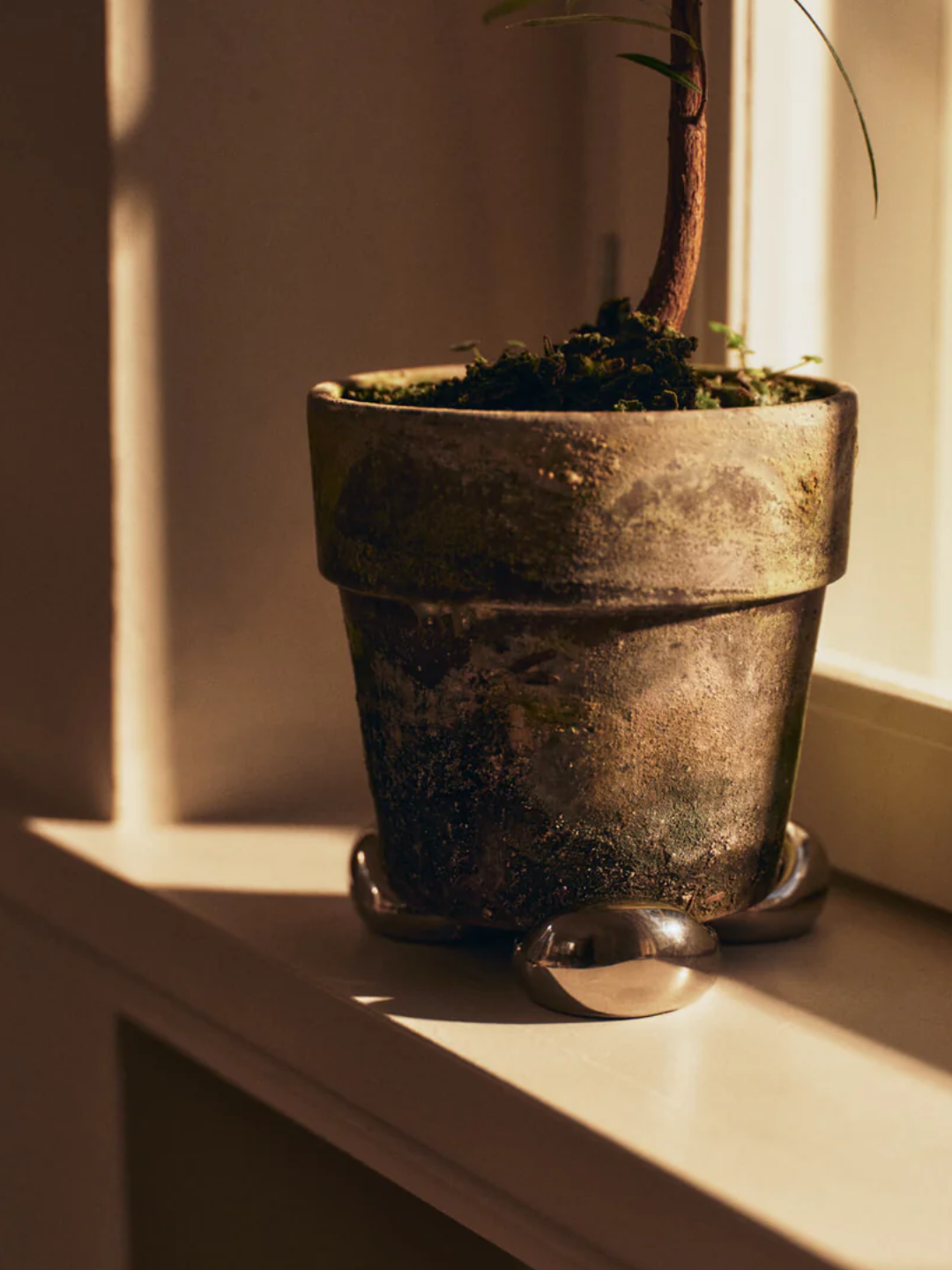 A set of silver planter feet from Ferm Living