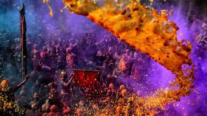 Hindus celebrate the Holi festival with water and colorful powders at the Radharani Temple in Uttar Pradesh, India