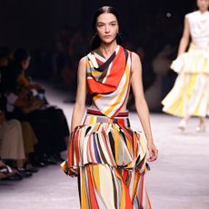 bottega veneta model wearing striped top and skirt