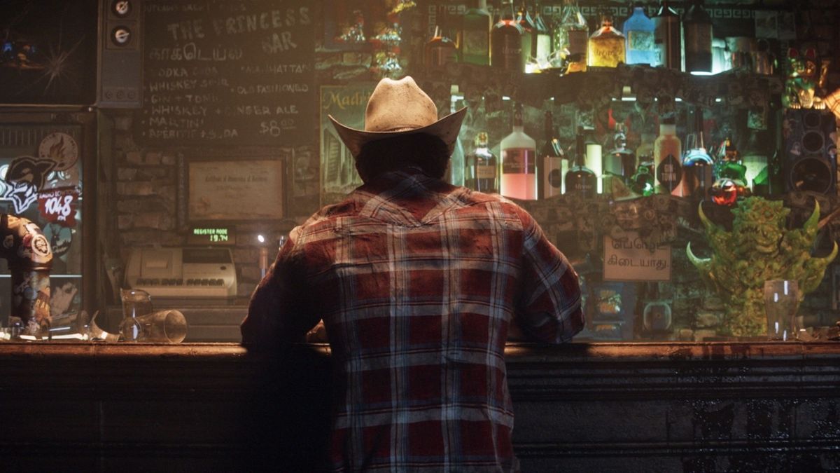 Wolverine sits at a bar with his back to the camera. He&#039;s wearing a cowboy hat and a red flannel shirt