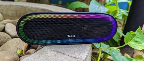 Tribit XSound Mega speaker outdoors on a stone structure