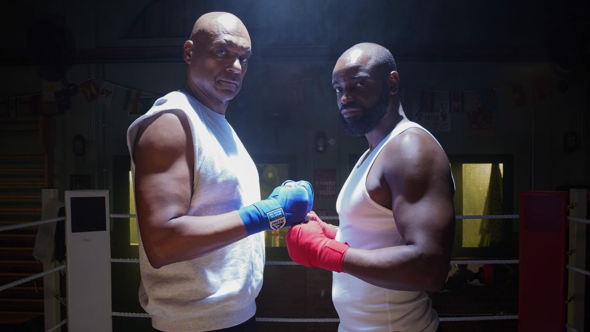 George Knight and Junior Knight wearing boxing gloves and standing opposite each other.