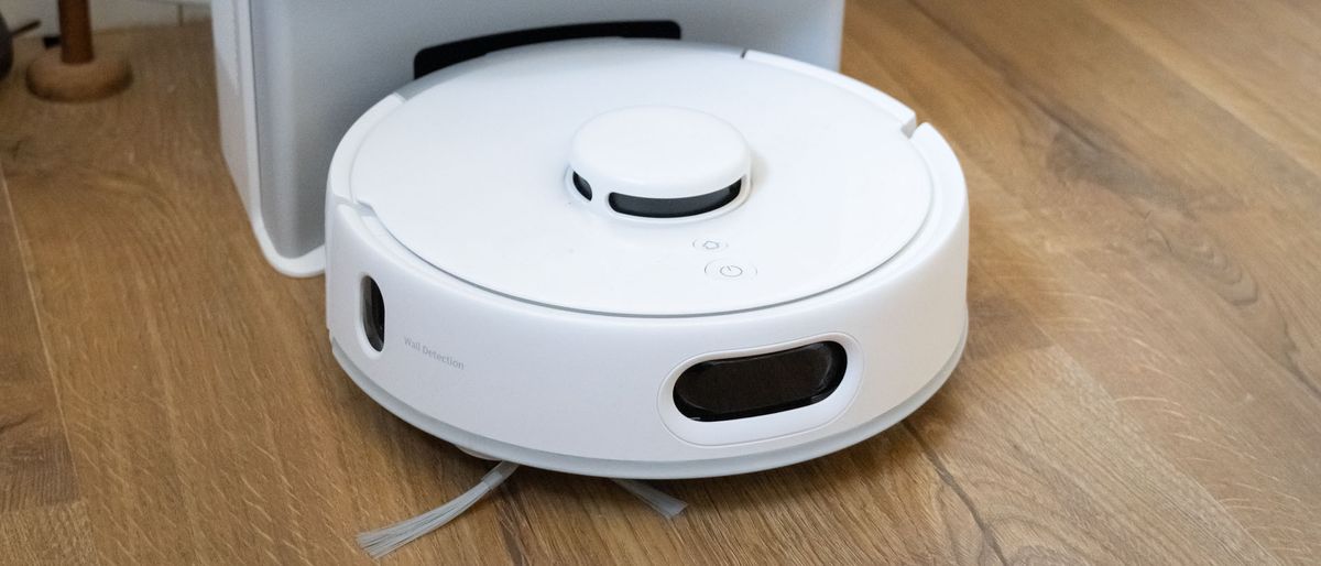 SwitchBot K10+ Pro mini robot vacuum in its dock