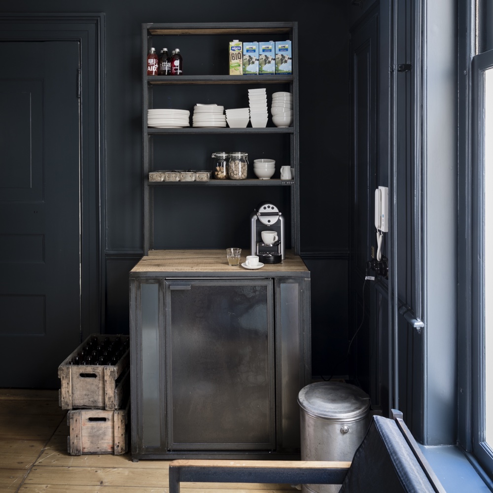 room with dark grey wall and shelves and wooden floor