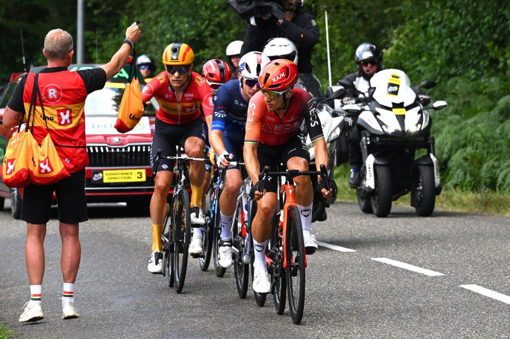 PAU FRANCE JULY 12 LR Magnus Cort of Denmark and Team UnoX Mobility Romain Gregoire of France and Team Groupama FDJ and Michal Kwiatkowski of Poland and Team INEOS Grenadiers compete at the feed zone during the 111th Tour de France 2024 Stage 13 a 1653km stage from Agen to Pau UCIWT on July 12 2024 in Pau France Photo by Tim de WaeleGetty Images