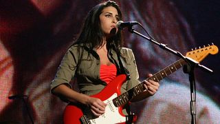 Amy Winehouse performs on stage as part of "The Miller Strat Pack" concert, at Wembley Arena on September 24, 2004 in London. The event pays homage to the Fender Stratocaster, is in aid of Nordoff-Robbins Music Therapy, and celebrates 50 years of the iconic guitar.