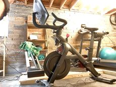 a Peloton Bike + sits in a garage