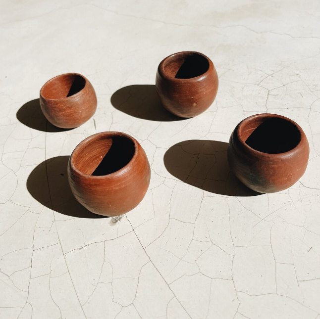 Red clay mezcal shot glasses.