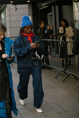 women wearing denim jacket and jeans and a red sweater in London