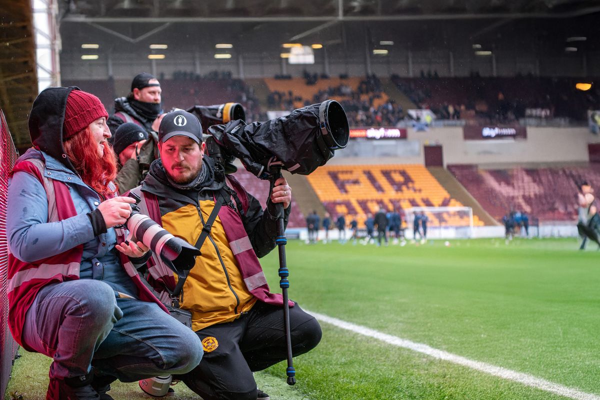 Photo of the pitchside at the Scottish Premiership clash between Motherwell and Falkirk, April 4, 2026, showing club photographer Raymond Davies and his mentee,