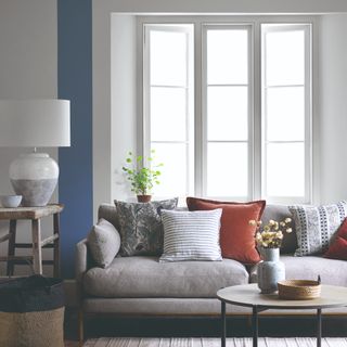 A living room with a large window and a sofa