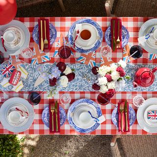 Overhead image of a party table with red and white gingham tablecloth