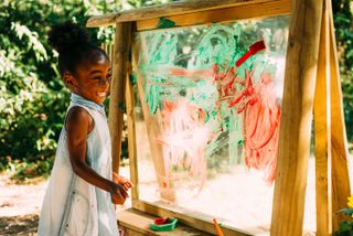 garden activities for kids: girl painting on easel