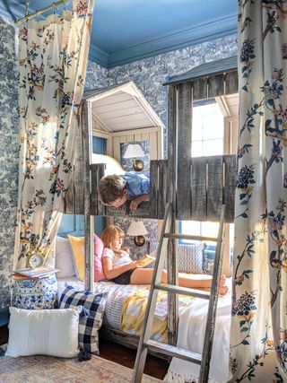 Blue bunk room makeover with feature woodland wallpaper