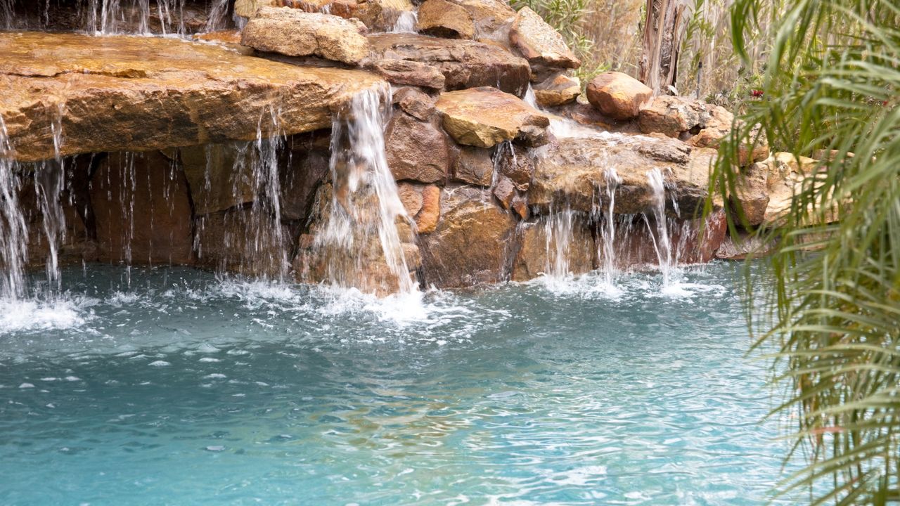 Swimming pool area with waterfall