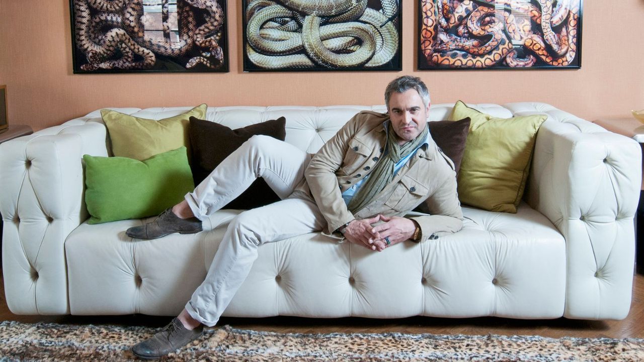 martyn lawrence bullard lying on a sofa for million dollar homes