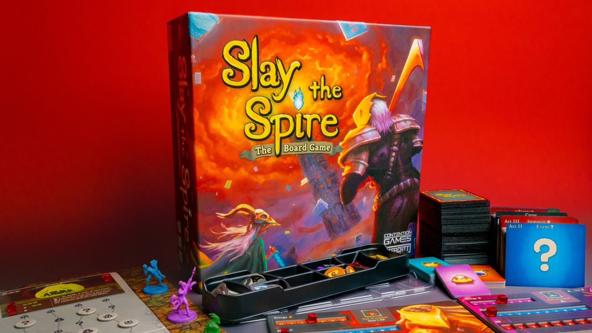 The Slay the Spire board game box with components and boards.