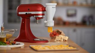 KitchenAid stand mixer with pasta press attachment making fusilli