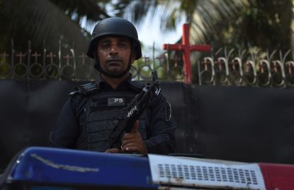 Pakistani police officer guards a church after Asia Bibi acquittal