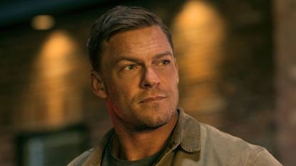 Reacher looks at something offscreen