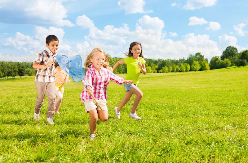 A group of children play outside.