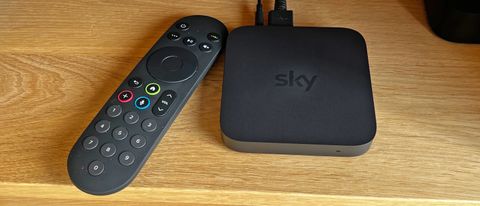 Sky Stream box on a wooden surface with its remote
