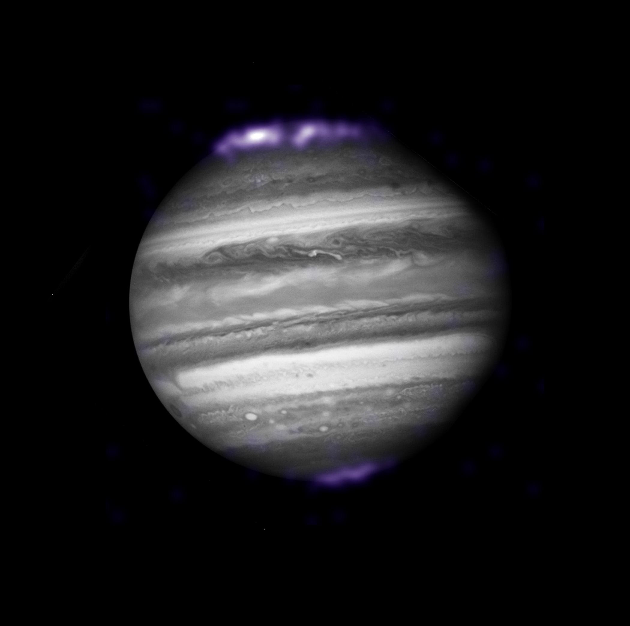 X-ray auroras on Jupiter, seen by the Chandra X-Ray Observatory, are overlaid here on an optical image from the Hubble Space Telescope taken at the same time.
