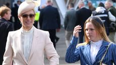 Zara Tindall and her daughter Mia arrive in the sunshine on Ladies Day, day two of the Grand National Festival horse race meeting at Aintree Racecourse