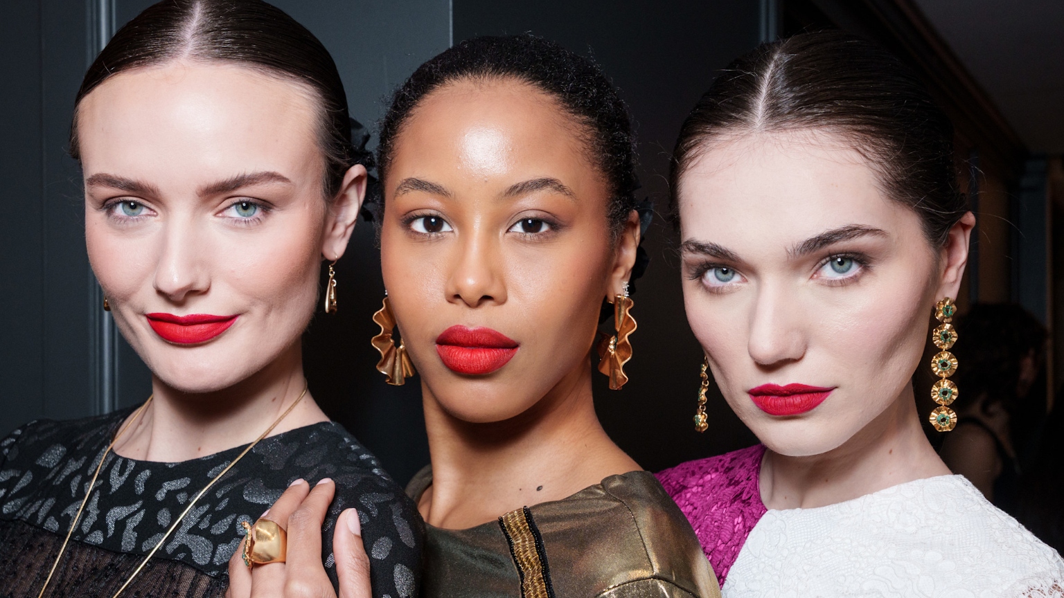 three women with glowing skin and long black lashes
