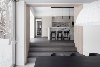 A white kitchen with dark grey flooring