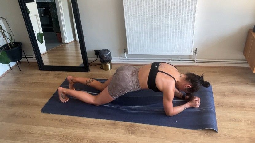 Writer Sam performing fishhook plank from knees on exercise mat during home workout
