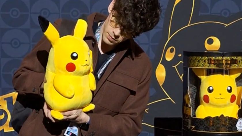 A man holds a Pikachu toy, with the same figure displayed in packaging to the right