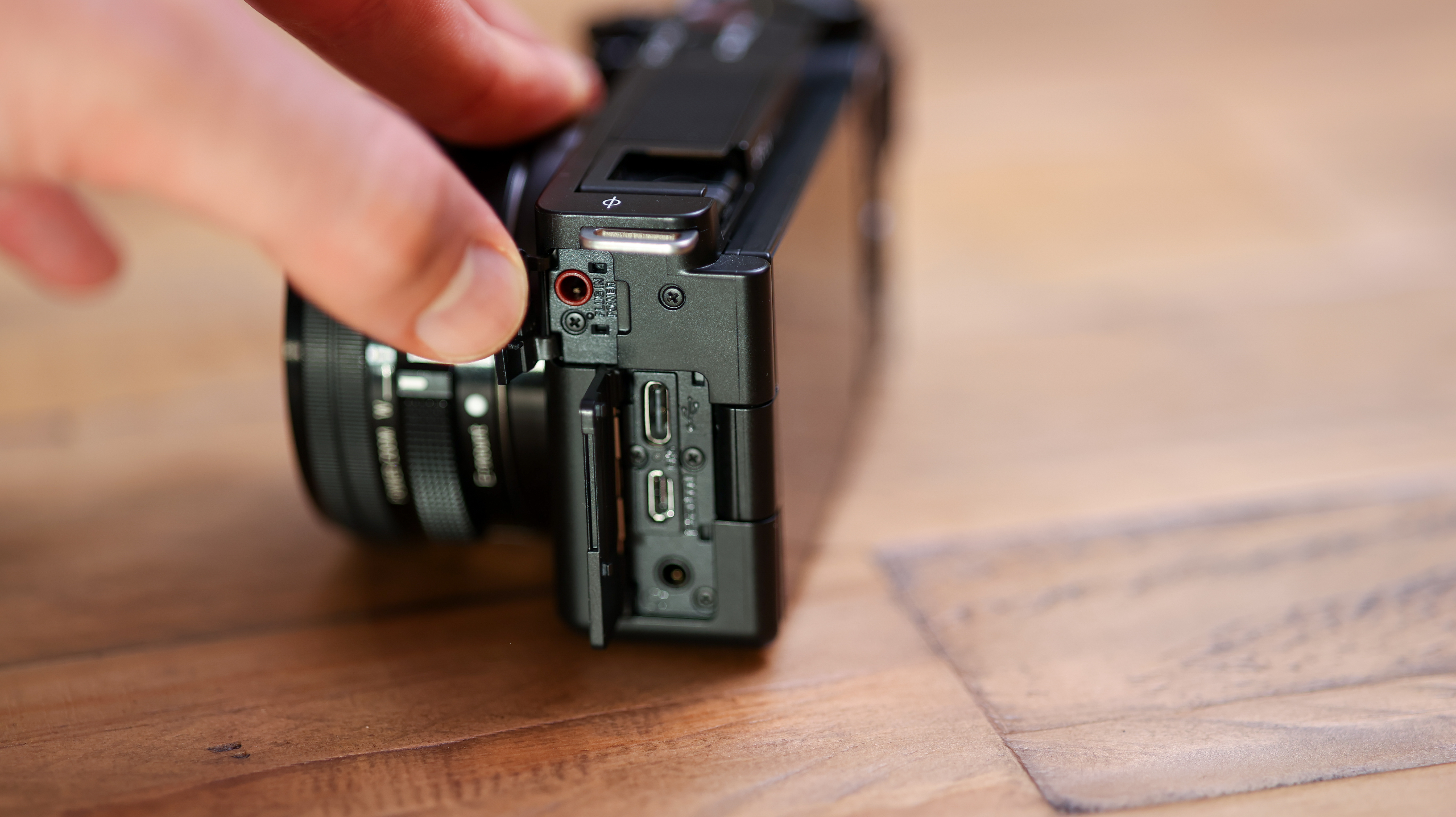 The open side door of the Sony ZV-E10 showing its ports