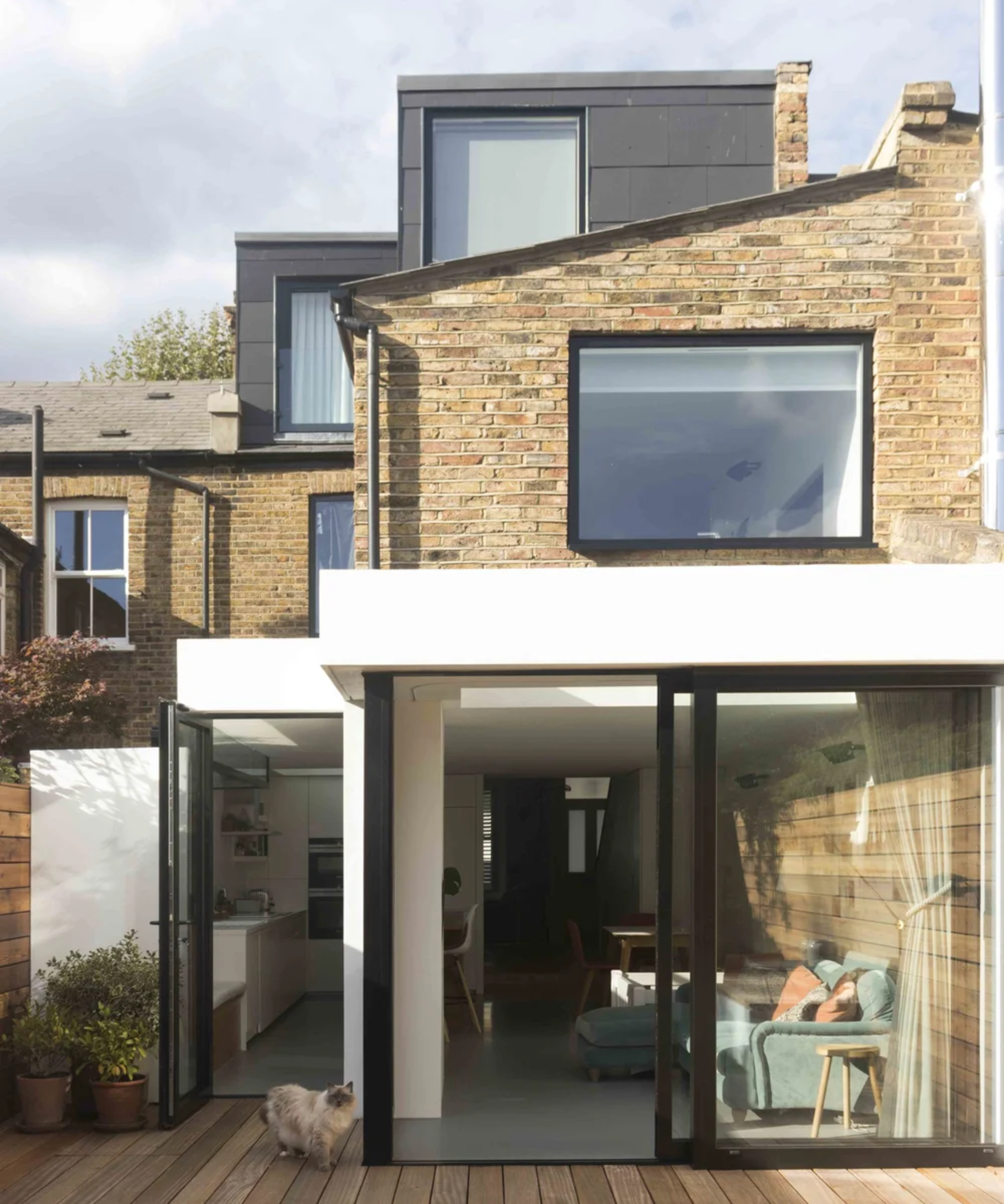 loft conversion clad in large black tiles with stepped design matching stepped appearance of ground floor extension