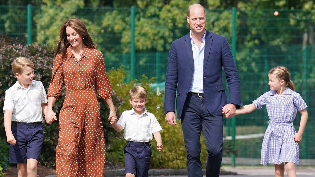 Prince William and Kate Middleton hold hands with their three kids