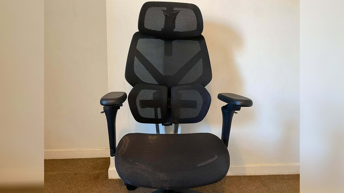 ThunderX3 chair set up in front of a white wall.
