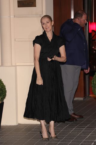 celine dion wearing a black dress in paris