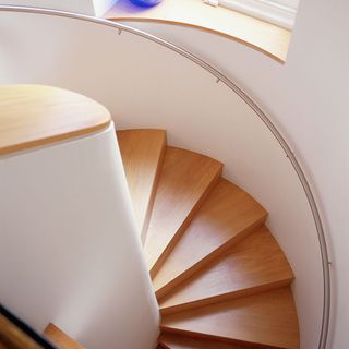 Spiral staircase with curved steel handrail