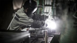 Merida factory employee welding a frame