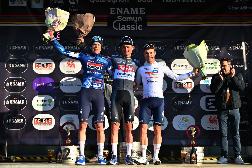 DOUR BELGIUM MARCH 04 LR Paul Magnier of France and Team Soudal QuickStep on second place race winner Mathieu van der Poel of Netherlands and Team Alpecin Deceuninck and Emilien Jeanniere of France and Team TotalEnergies on third place pose on the podium ceremony after the 57th Ename Samyn Classic 2025 a 1991km one day race from Quaregnon to Dour on March 04 2025 in Dour Belgium Photo by Luc ClaessenGetty Images