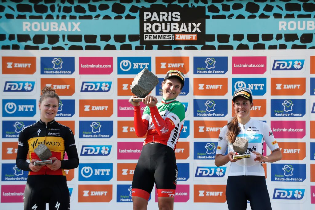 ROUBAIX FRANCE APRIL 16 LR Lotte Kopecky of Belgium and Team SD Worx on second place race winner Elisa Longo Borghini of Italy and Team Trek Segafredo holds up her Cobbleston trophy and Lucinda Brand of Netherlands and Team Trek Segafredo on third place pose on the podium during the podium ceremony after the 2nd ParisRoubaix 2022 Womens Elite a 1247km one day race from Denain to Roubaix ParisRoubaixFemmes ParisRoubaix on April 16 2022 in Roubaix France Photo by Bas CzerwinskiGetty Images