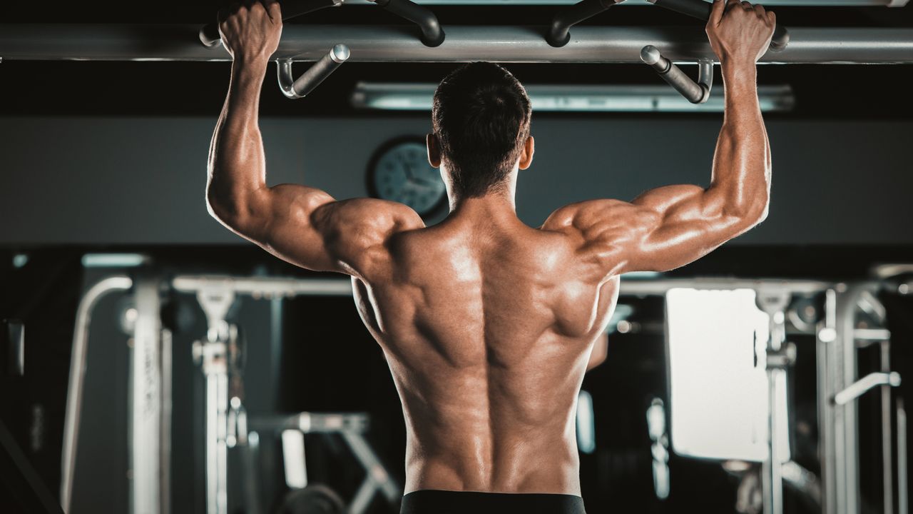 Person performing a pull up in the gym