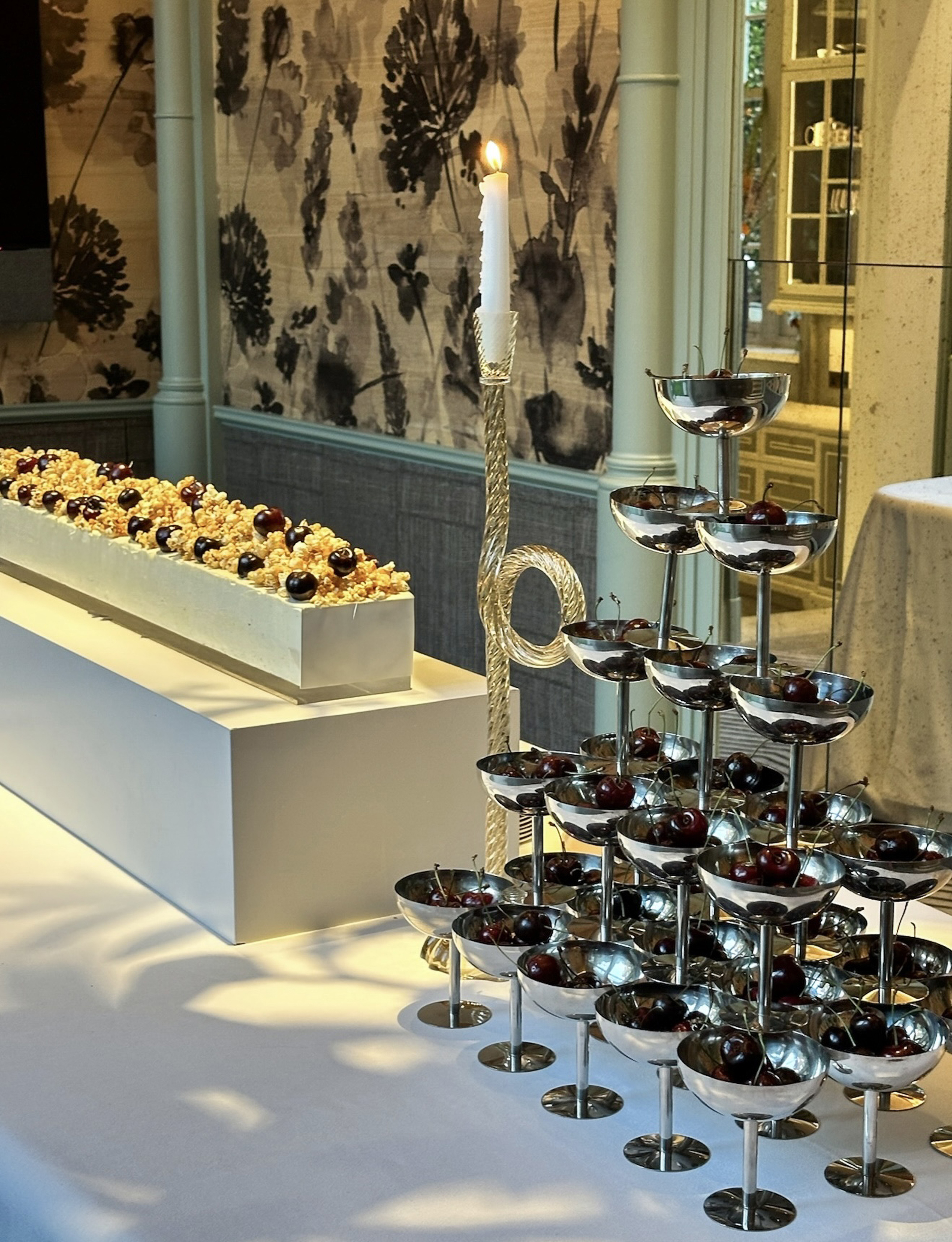 a table with a pyramid of chrome coupes stacked up