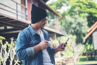 Hipster man resting at home balcony