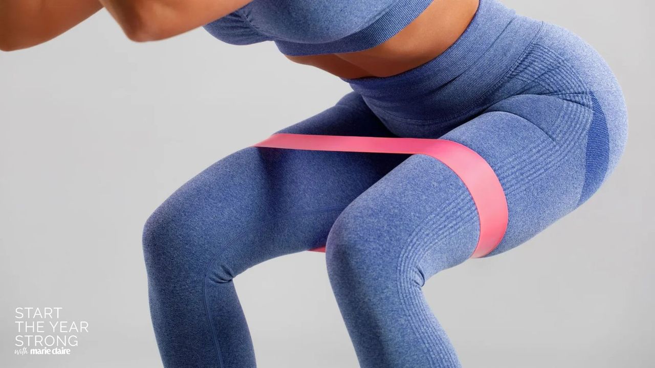 A woman doing one of the best resistance band workouts for beginners